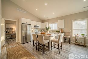 Columbiana house for rent - A kitchen with a refrigerator, sink, and dining table.