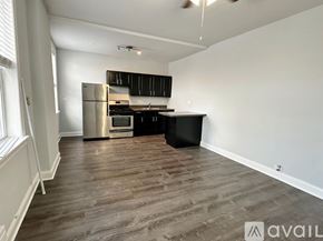 Chicago apartment for rent - A kitchen with a refrigerator, oven, and cabinets.