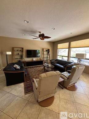 Surprise apartment for rent - A living room with a black ottoman and a brown rug.