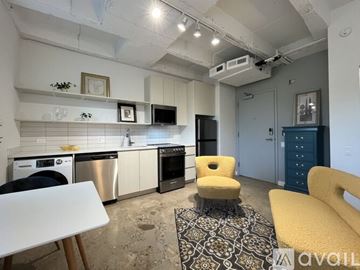 Chicago apartment for rent - A kitchen with a white table and yellow chairs.