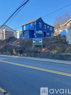 Morgantown apartment for rent - A blue house is for rent and is located on a hill.