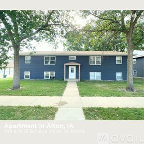 Alton apartment for rent - Apartment building with a blue exterior and a white door.