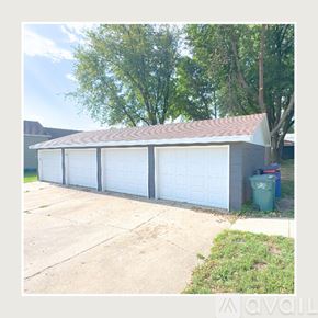 Alton apartment for rent - A two-car garage with a brown roof and white doors.