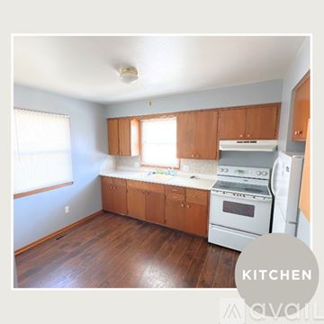 Alton apartment for rent - A kitchen with wooden cabinets and white appliances.