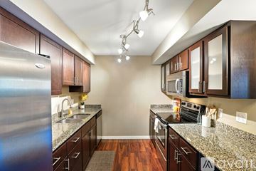 Iowa City apartment for rent - A kitchen with brown cabinets and granite countertops.