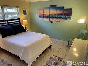 Fort Lauderdale apartment for rent - A bedroom with a bed, a bench, and a painting on the wall.