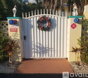 Fort Lauderdale apartment for rent - A white gate with a wreath and a sign that says "No Trespassing" is closed.