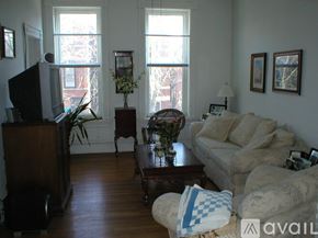 Chicago apartment for rent - A living room with a couch, a chair, a coffee table, and a television.