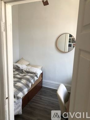 Chicago apartment for rent - A bedroom with a bed, chair, and mirror.