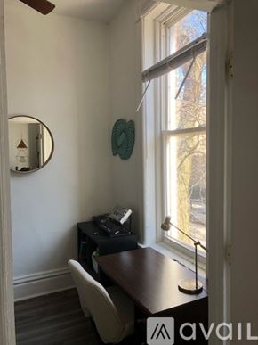 Chicago apartment for rent - A room with a desk and a chair in front of a window.