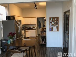 Chicago apartment for rent - A kitchen with a refrigerator, table, and chairs.