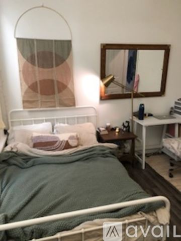 Chicago apartment for rent - A bedroom with a bed, nightstand, and a mirror on the wall.