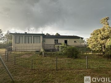 Peyton house for rent - A kitchen with blue cabinets and a stainless steel refrigerator.