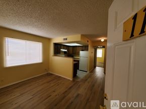 Bullhead City apartment for rent - A room with wooden floors and a white door with a number 11 on it.