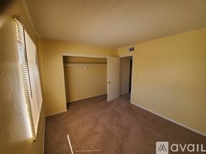 Bullhead City apartment for rent - A room with a carpeted floor and a window with blinds.