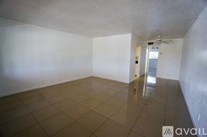 Deerfield Beach apartment for rent - A spacious room with tiled flooring and a ceiling fan.