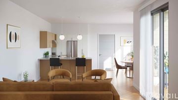 Altoona apartment for rent - A living room with a brown couch and a dining table with chairs.