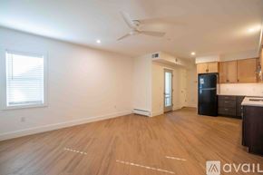 Altoona apartment for rent - A spacious room with wooden flooring and a ceiling fan.