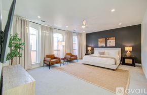 Houston townhouse for rent - A bedroom with a large bed and a television on the left side.