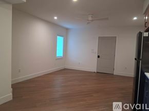 Altoona apartment for rent - A room with wooden floors and a ceiling fan.