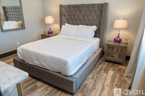 Los Angeles house for rent - A bedroom with a large bed and two purple lamps.