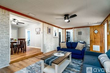 Jacksonville house for rent - A living room with a blue couch and a wooden coffee table.