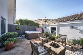 Huntington Beach house for rent - A patio with a table, chairs, and a hot tub.