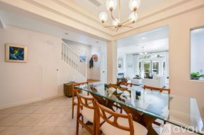 Huntington Beach house for rent - A dining room with a glass table and chairs.