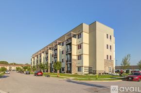 Mankato apartment for rent - A modern apartment building with cars parked in front.
