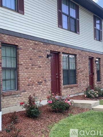 Cincinnati apartment for rent - A house with a red door and windows.