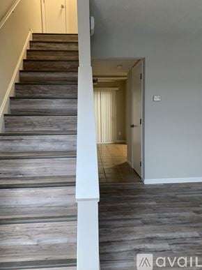 Cincinnati apartment for rent - A hallway with a staircase and a door.
