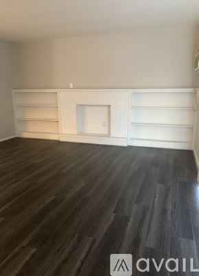 Cincinnati apartment for rent - A room with wooden flooring and white shelves.