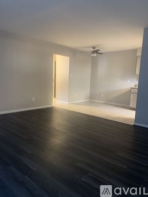 Cincinnati apartment for rent - A room with a ceiling fan and a door leading to another room.