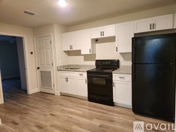 Poinciana apartment for rent - A kitchen with black appliances and white cabinets.