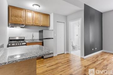 Chicago apartment for rent - A kitchen with wooden cabinets and a marble countertop.