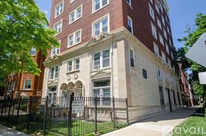 Chicago apartment for rent - A tall building with a red brick facade and a white stone section in the middle.