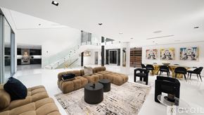 Los Angeles house for rent - A modern dining room with a glass table and green chairs.