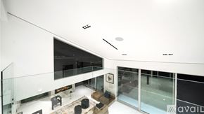 Los Angeles house for rent - A modern bedroom with a large bed and a fireplace.
