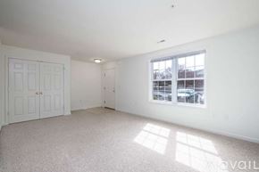 Millersville apartment for rent - A room with a carpeted floor and a window showing a tree outside.