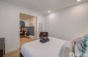 Houston house for rent - A bedroom with a large bed and a chair in the corner.