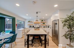 Houston house for rent - A modern kitchen with a dining table and chairs.