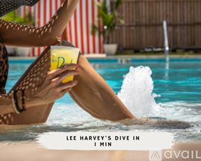 Dallas townhouse for rent - A woman in a leopard print bikini is holding a drink while sitting in a pool.