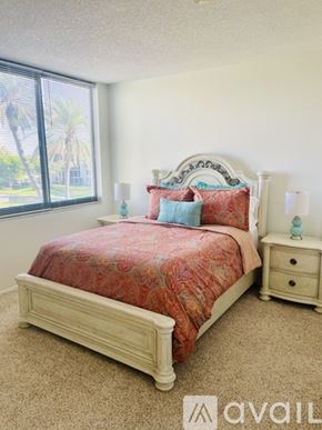 Longboat Key condo for rent - A bedroom with a bed, nightstand, and window.