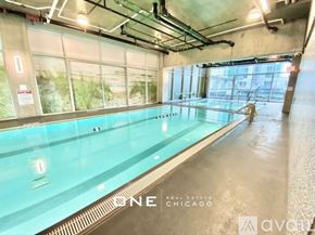 Chicago apartment for rent - A large indoor swimming pool with a glass wall on one side.