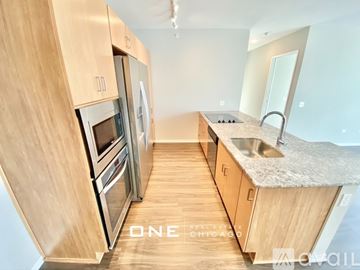 Chicago apartment for rent - A kitchen with wooden cabinets and stainless steel appliances is available for rent in Chicago.
