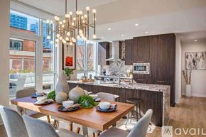 Chicago apartment for rent - A modern dining room with a wooden table set for a meal.