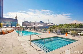 Chicago apartment for rent - A large outdoor swimming pool with sun loungers and umbrellas.