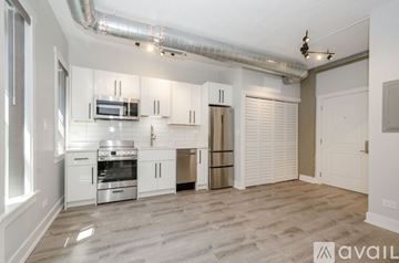 Chicago apartment for rent - A kitchen with white cabinets and stainless steel appliances.