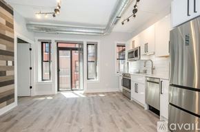 Chicago apartment for rent - A kitchen with white cabinets and a stainless steel refrigerator.