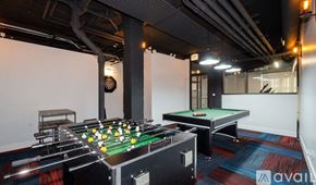 Chicago apartment for rent - A pool table with a green felt cloth and white balls is in the center of the image.